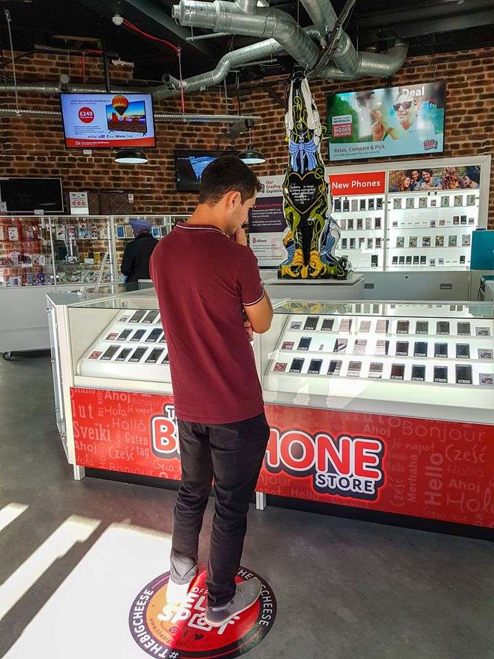 A customer browsing the large selection of phones available at The Big Phone Store